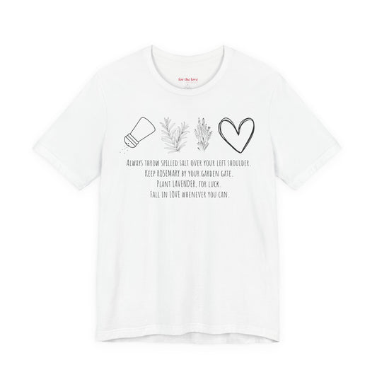 white graphic t-shirt featuring rosemary, lavender, salt, and heart illustrations with a practical magic inspired quote