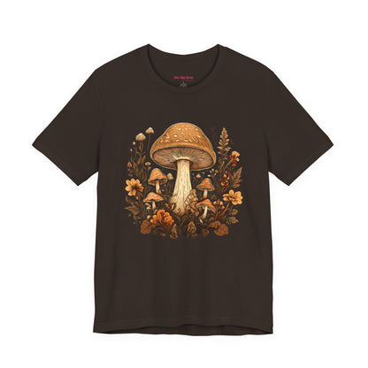 Brown graphic t-shirt featuring vintage style mushrooms surrounded by earthy botanical flowers and woodland plants