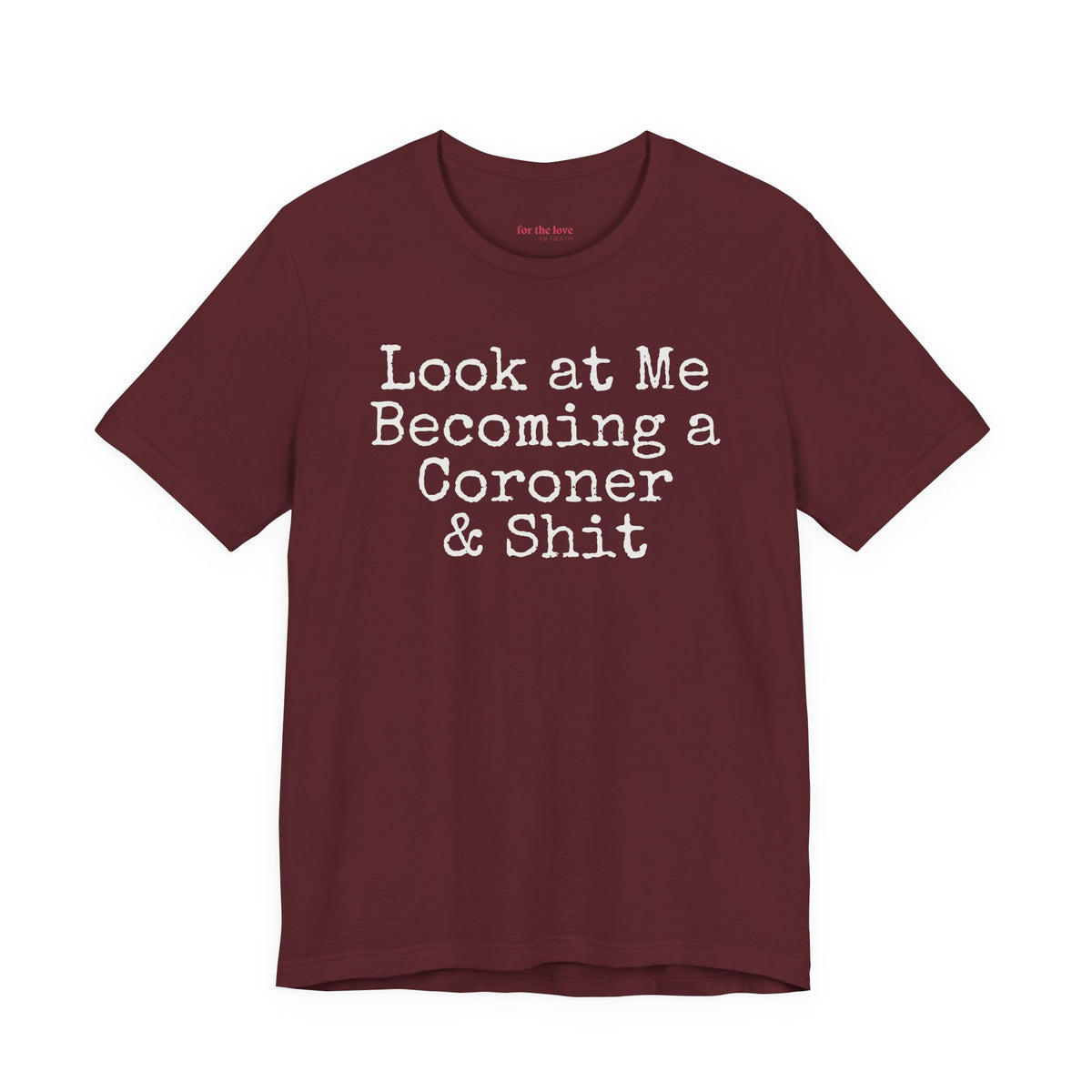 Marron funny coroner T-shirt featuring the phrase Look at Me Becoming a Coroner & Shit in vintage typewriter-style lettering.
