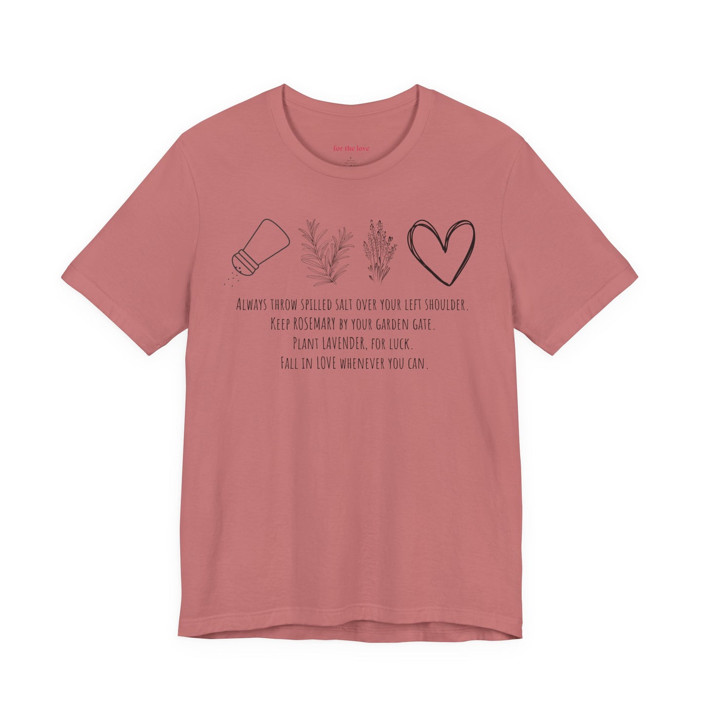 pink graphic t-shirt featuring rosemary, lavender, salt, and heart illustrations with a practical magic inspired quote