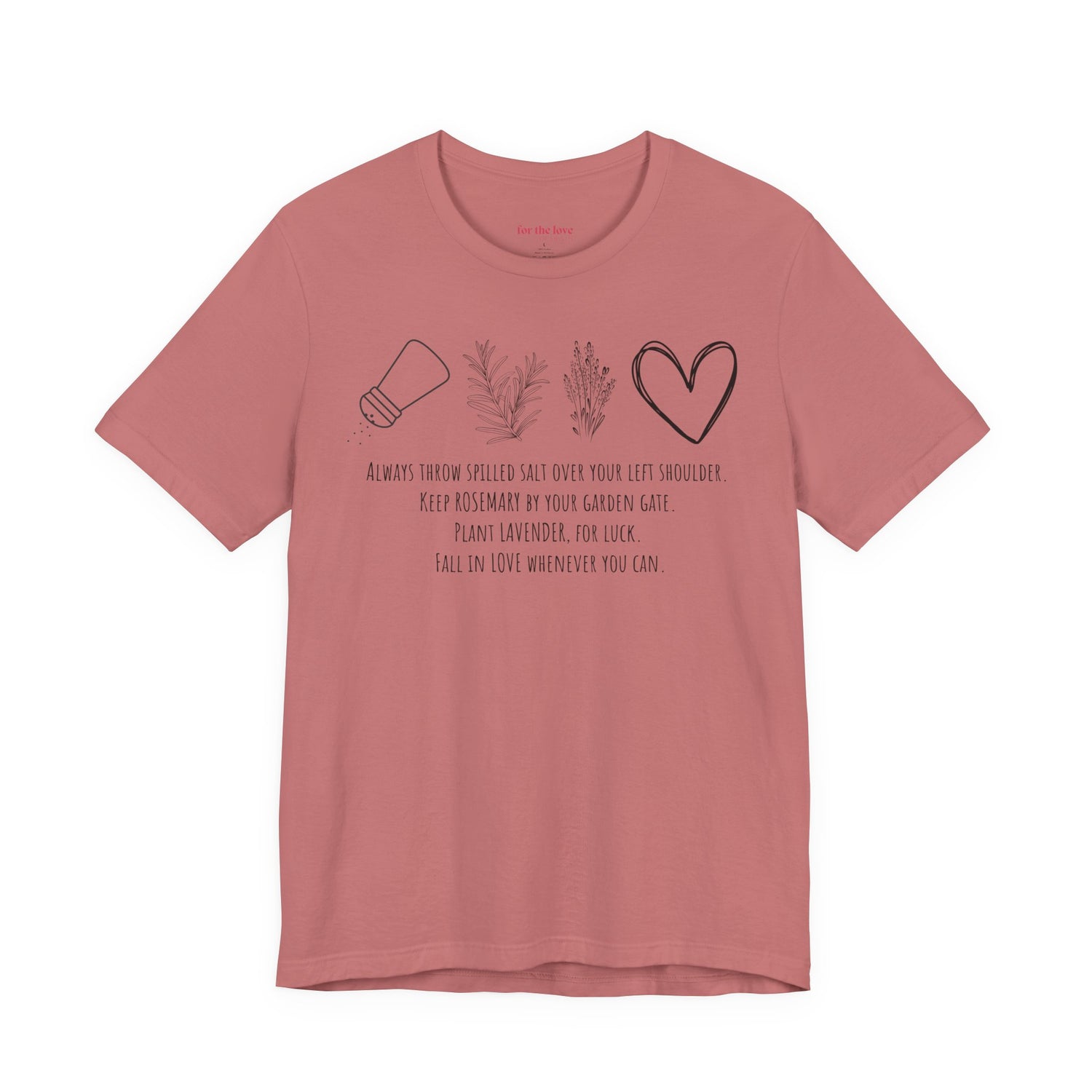 pink graphic t-shirt featuring rosemary, lavender, salt, and heart illustrations with a practical magic inspired quote