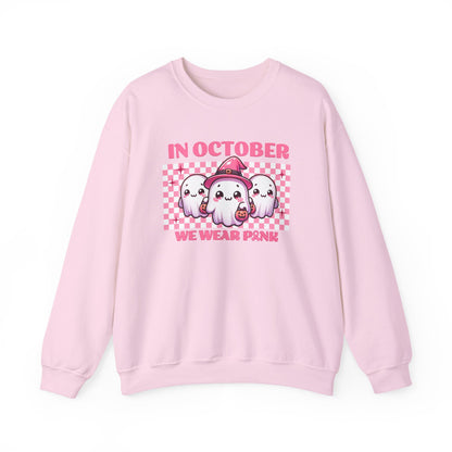 pink sweatshirt with cute pink ghosts and the phrase in october we wear pink for breast cancer awareness month and halloween season