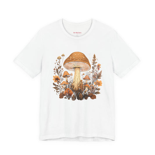 white graphic t-shirt featuring vintage style mushrooms surrounded by earthy botanical flowers and woodland plants